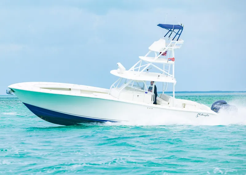 Slide: The Image of 2011 Yellowfin 42 Offshore boat cruising on turquoise water. - 25