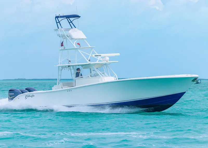 Slide: The Image of 2011 Yellowfin 42 Offshore boat cruising on turquoise waters. - 26