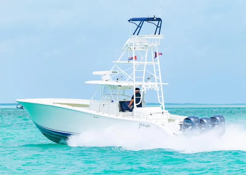 Slide: The Image of 2011 Yellowfin 42 Offshore boat cruising on turquoise waters. - 28