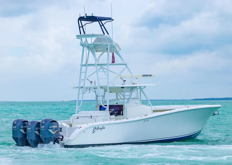Slide: The Image of 2011 Yellowfin 42 Offshore boat with triple Yamaha engines on turquoise water. - 29