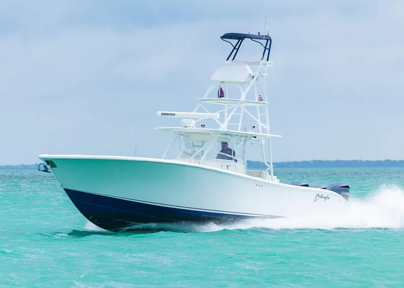Slide: The Image of 2011 Yellowfin 42 Offshore boat cruising on turquoise water. - 30