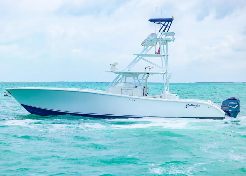Slide: The Image of 2011 Yellowfin 42 Offshore boat cruising on turquoise waters. - 4