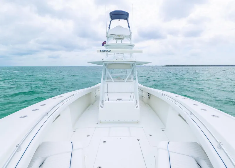 Slide: The Image of 2011 Yellowfin 42 Offshore boat on open sea under cloudy sky. - 5