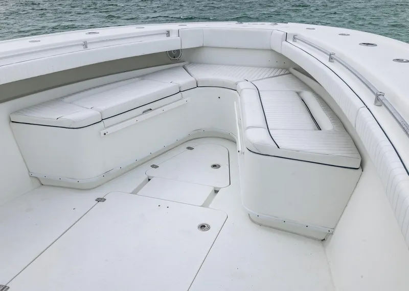 Slide: The Image of 2011 Yellowfin 42 Offshore boat with spacious white seating area on deck. - 6