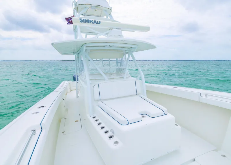 Slide: The Image of 2011 Yellowfin 42 Offshore boat on turquoise water under cloudy sky. - 8