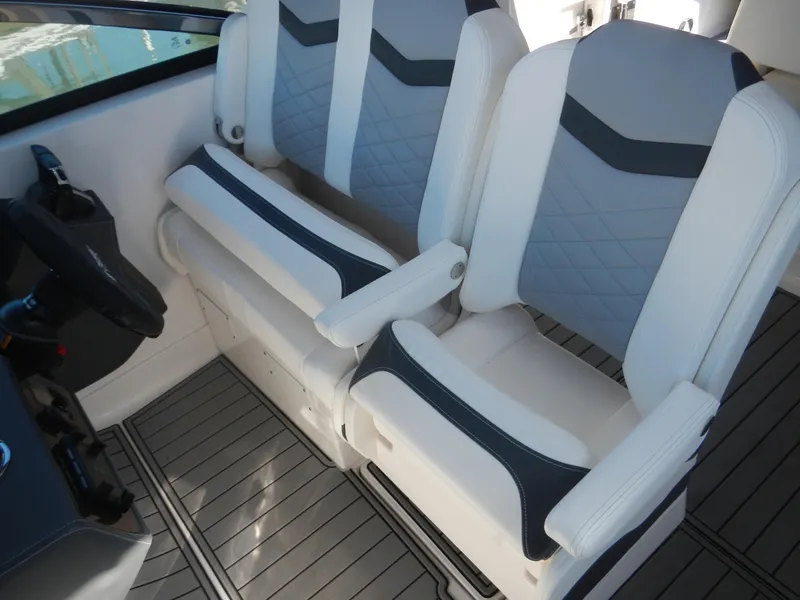 Slide: The Image of 2023 Chaparral 280 OSX boat interior with dual gray and white captain seats. - 11