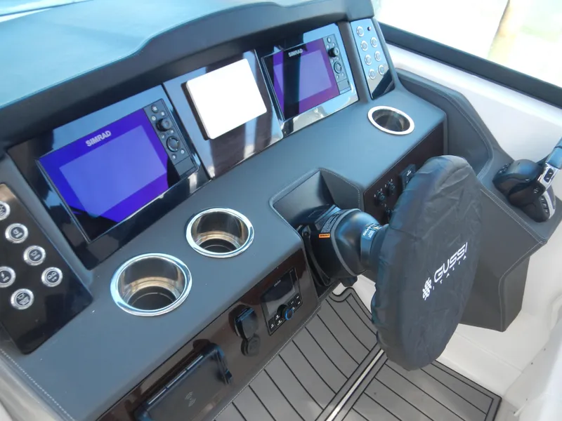Slide: The Image of 2023 Chaparral 280 OSX helm with advanced navigation displays and controls. - 12