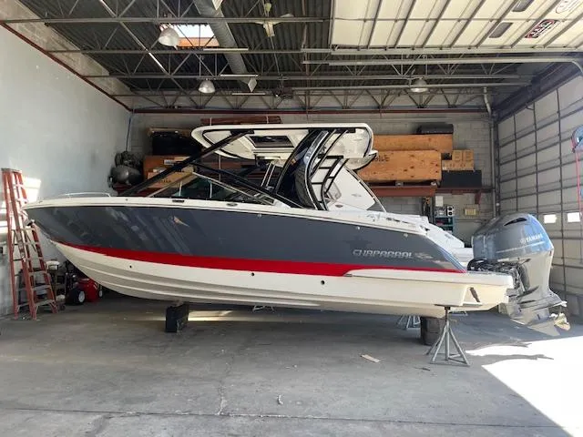 Slide: The Image of 2023 Chaparral 280 OSX boat in a garage, featuring sleek design and modern outboard engines. - 14