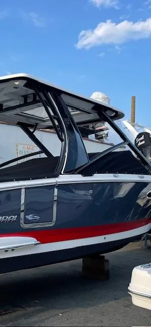 Slide: The Image of 2023 Chaparral 280 OSX boat with sleek design, docked under a clear blue sky. - 15