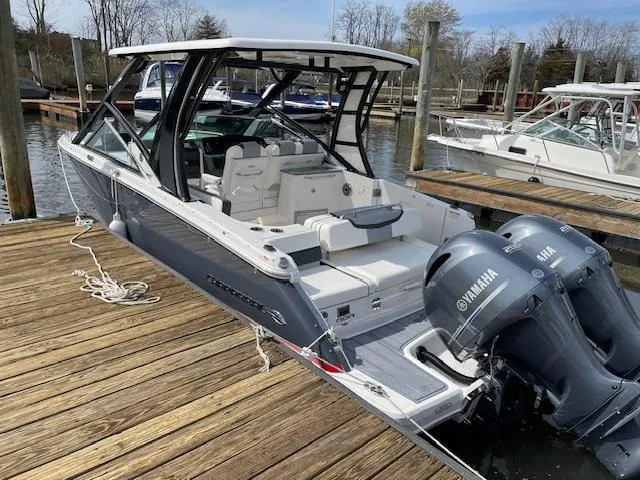 Slide: The Image of Chaparral 280 OSX 2023 boat docked with twin Yamaha engines. - 16