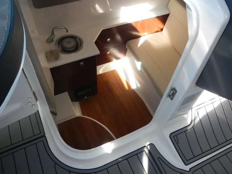 Slide: The Image of 2023 Chaparral 280 OSX cabin interior with kitchenette and seating area. - 7