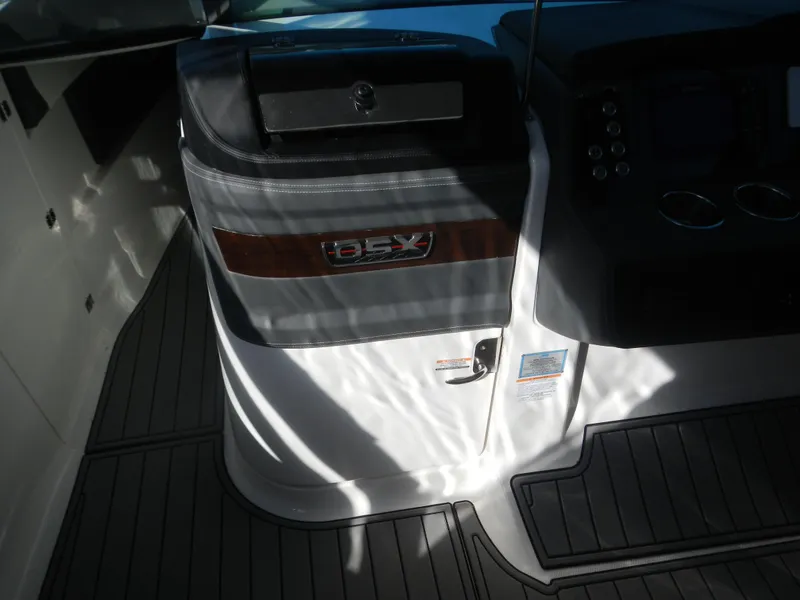 Slide: The Image of 2023 Chaparral 280 OSX boat interior with control panel and branding. - 8