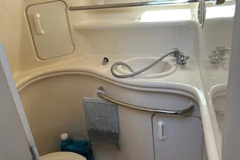 Slide: The Image of 2001 Sea Ray 340 Sundancer bathroom with sink, shower, and storage compartments. - 10