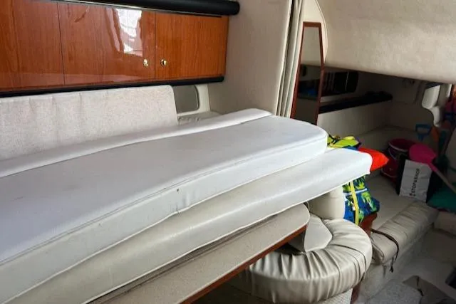 Slide: The Image of Interior of 2001 Sea Ray 340 Sundancer with cushions and wooden cabinetry. - 6