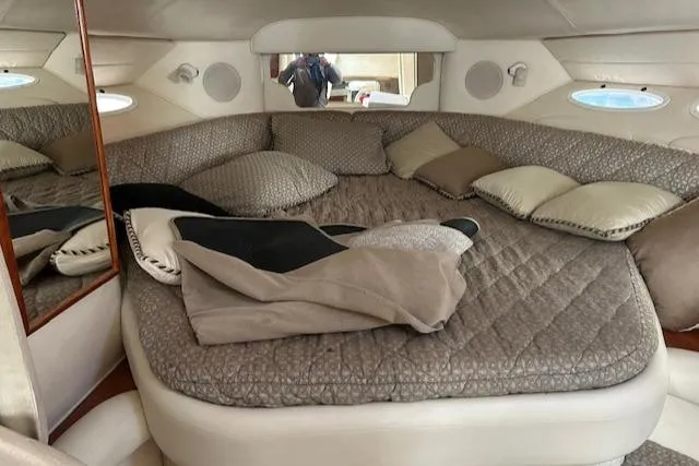 Slide: The Image of Cozy cabin interior of 2001 Sea Ray 340 Sundancer with plush bedding and pillows. - 8