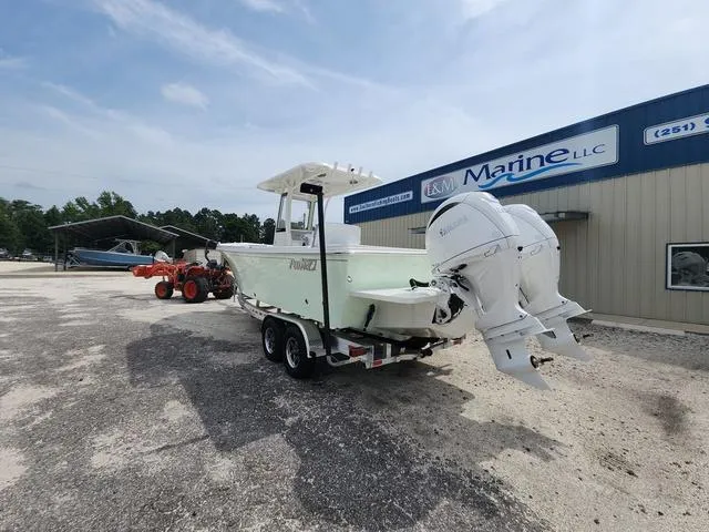 Slide: The Image of 2025 Parker 2600 CC boat with dual engines at a marine dealership. - 7