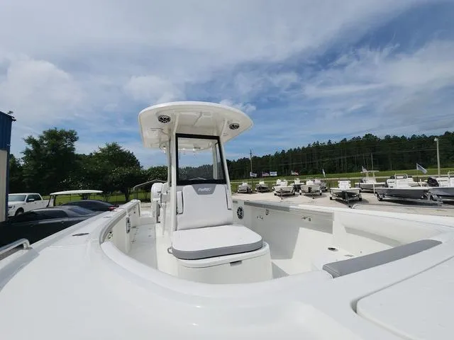 Slide: The Image of 2025 Parker 2600 CC boat with center console, displayed outdoors under a clear sky. - 8