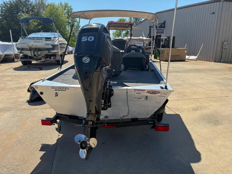 Slide: The Image of 2020 Bass Tracker Classic boat with 50 HP engine, parked outdoors. - 10