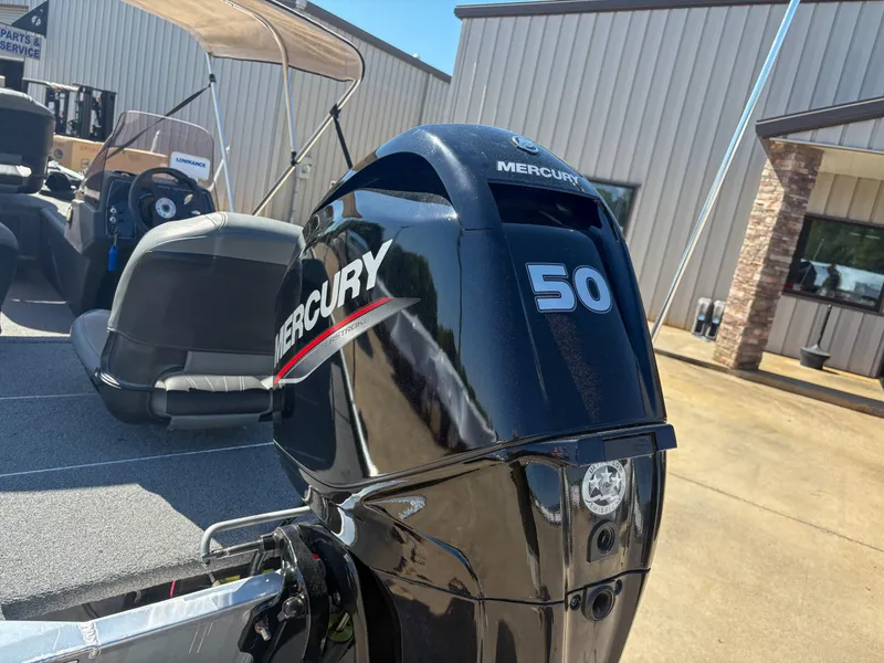 Slide: The Image of 2020 Bass Tracker Classic with Mercury 50 horsepower engine, parked outside a building. - 11