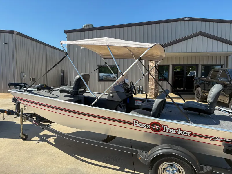 Slide: The Image of 2020 Bass Tracker Classic boat with canopy parked outside a building. - 6