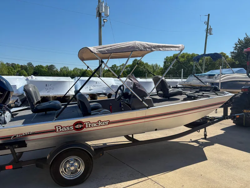 Slide: The Image of 2020 Bass Tracker Classic boat with canopy on a trailer, parked outdoors. - 9