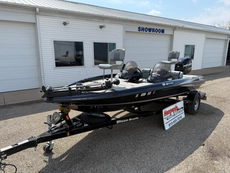 Slide: The Image of 2009 Triton 18 Explorer boat on trailer outside showroom. - 1