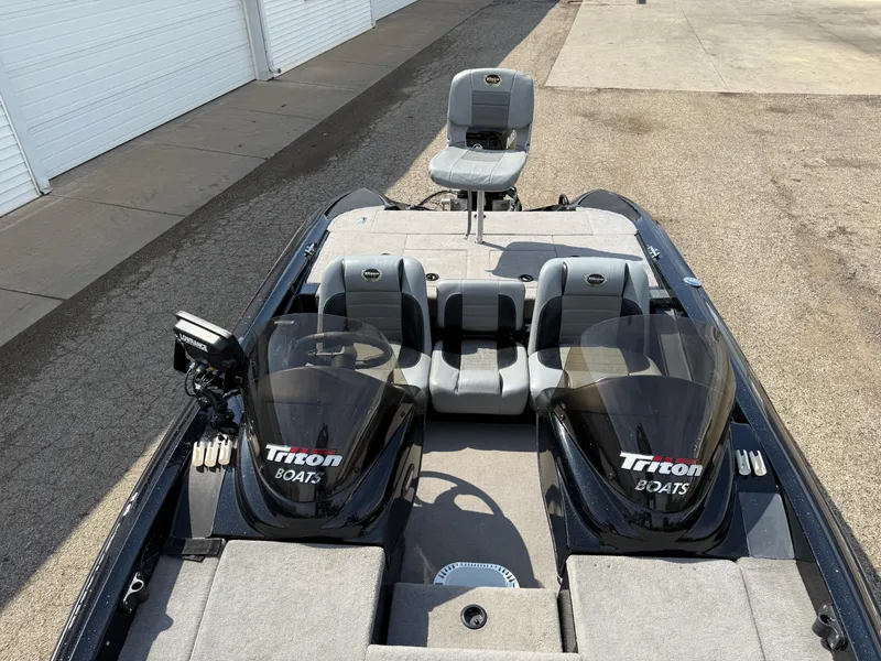 Slide: The Image of 2009 Triton 18 Explorer boat with dual seats and sleek design. - 11