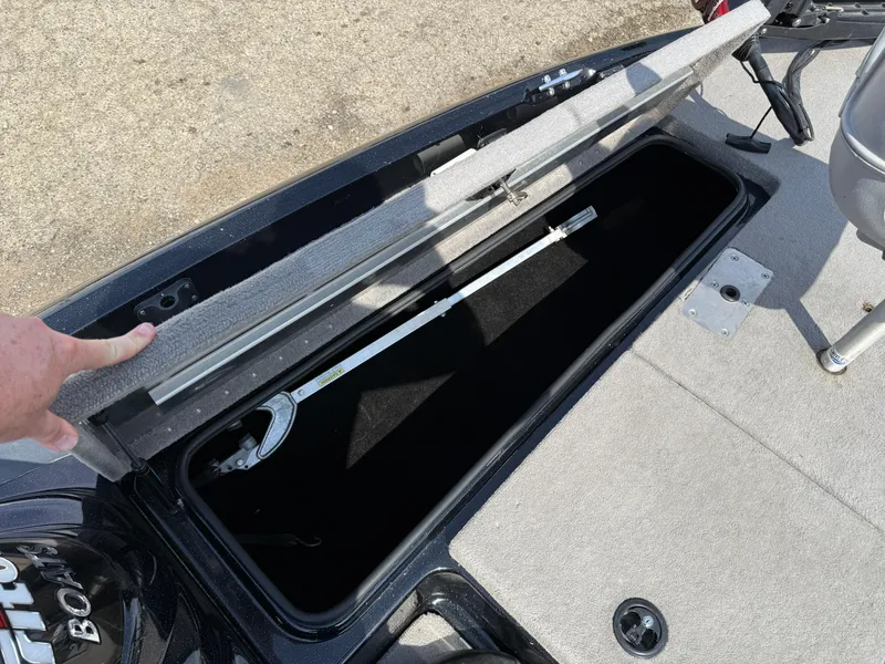Slide: The Image of Open storage compartment in 2009 Triton 18 Explorer boat, showing interior space. - 13
