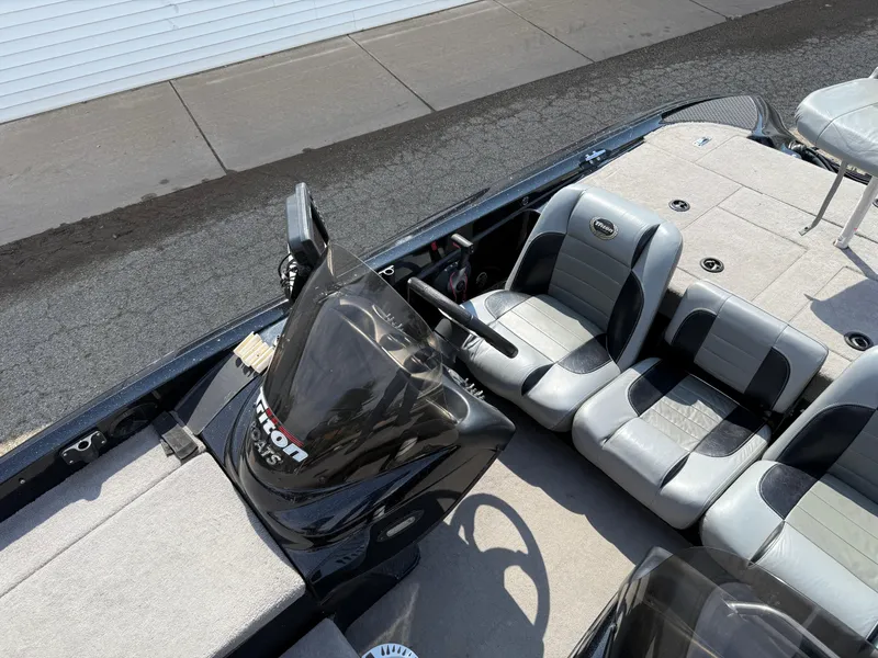 Slide: The Image of 2009 Triton 18 Explorer boat interior with seating and steering wheel. - 16