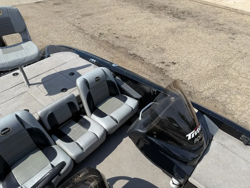 Slide: The Image of 2009 Triton 18 Explorer boat interior with gray seating and steering console. - 17