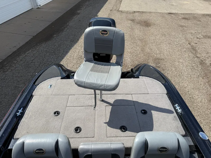 Slide: The Image of 2009 Triton 18 Explorer boat with gray seating and spacious deck. - 18