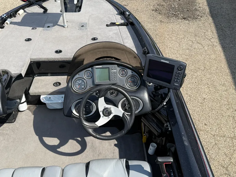 Slide: The Image of 2009 Triton 18 Explorer boat dashboard with steering wheel and navigation system. - 19