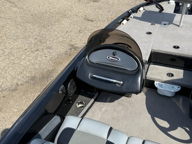 Slide: The Image of 2009 Triton 18 Explorer boat interior with steering console and seating. - 20