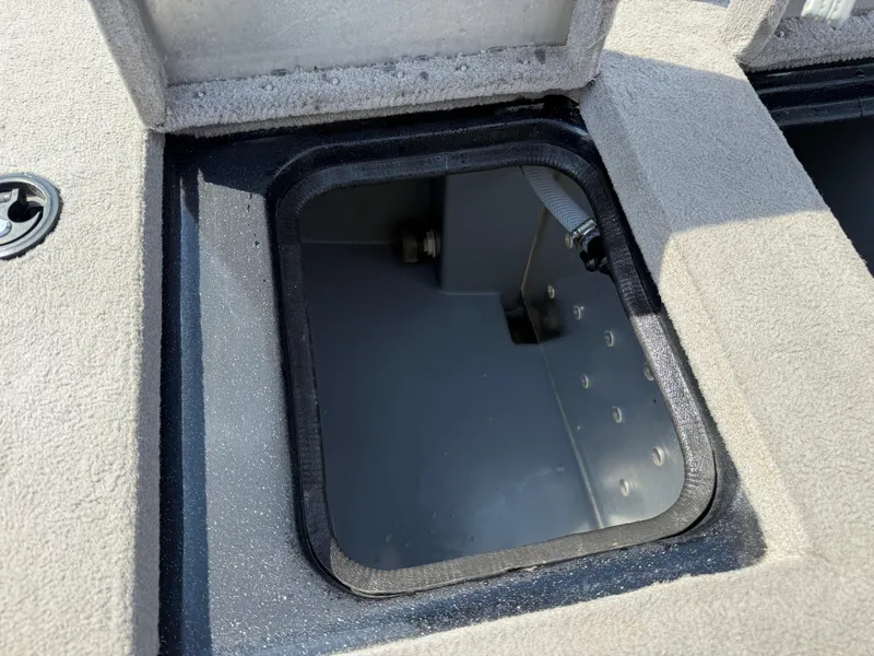 Slide: The Image of Open storage compartment on a 2009 Triton 18 Explorer boat. - 26