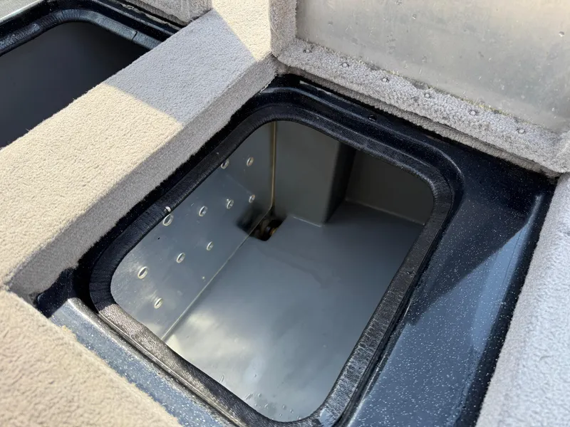 Slide: The Image of Open storage compartment in 2009 Triton 18 Explorer boat. - 27