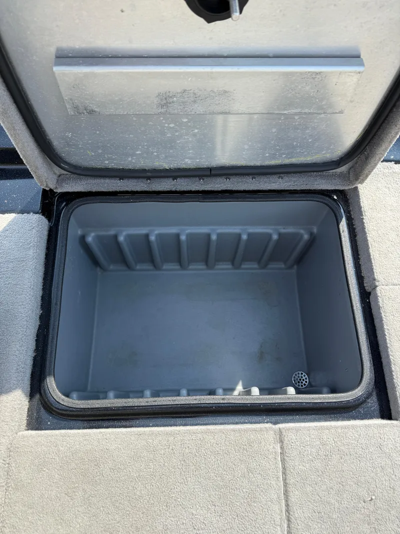 Slide: The Image of Open storage compartment in 2009 Triton 18 Explorer boat. - 29