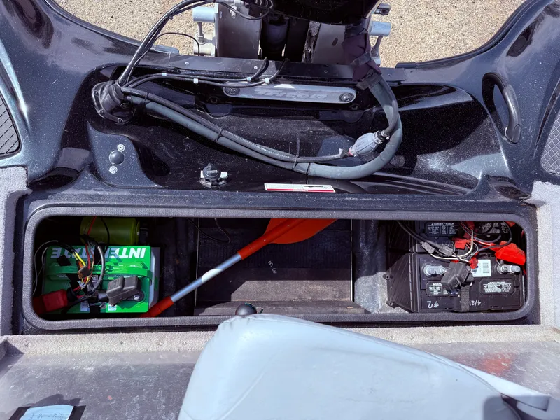 Slide: The Image of 2009 Triton 18 Explorer boat storage compartment with battery and equipment. - 30