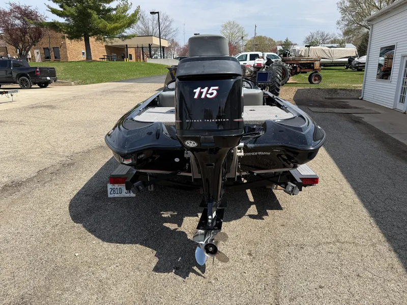 Slide: The Image of 2009 Triton 18 Explorer boat with 115 horsepower engine, parked outdoors. - 6