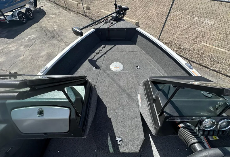 Slide: The Image of 2025 Lund 1775 Adventure Sport boat interior with open windshield and trolling motor. - 11