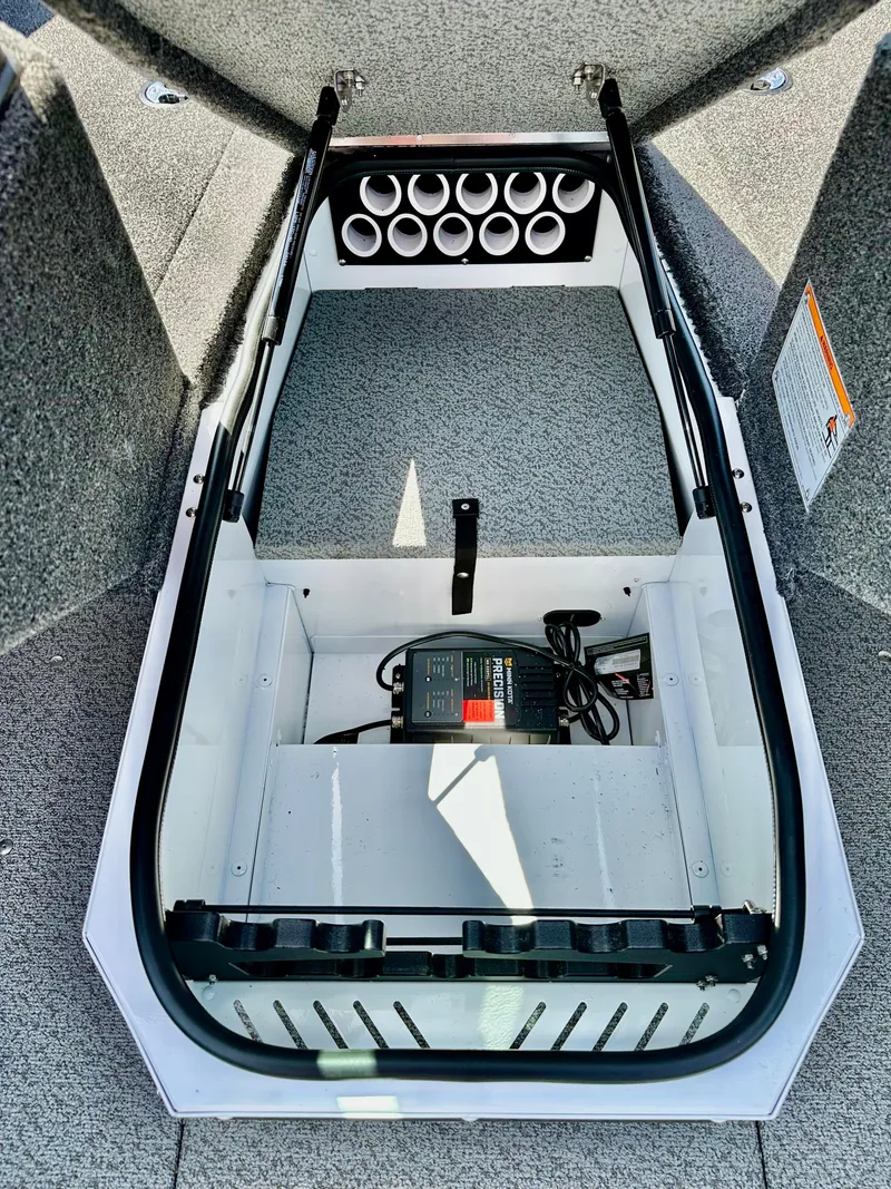 Slide: The Image of 2025 Lund 1775 Adventure Sport boat interior with storage compartment and rod holders. - 12