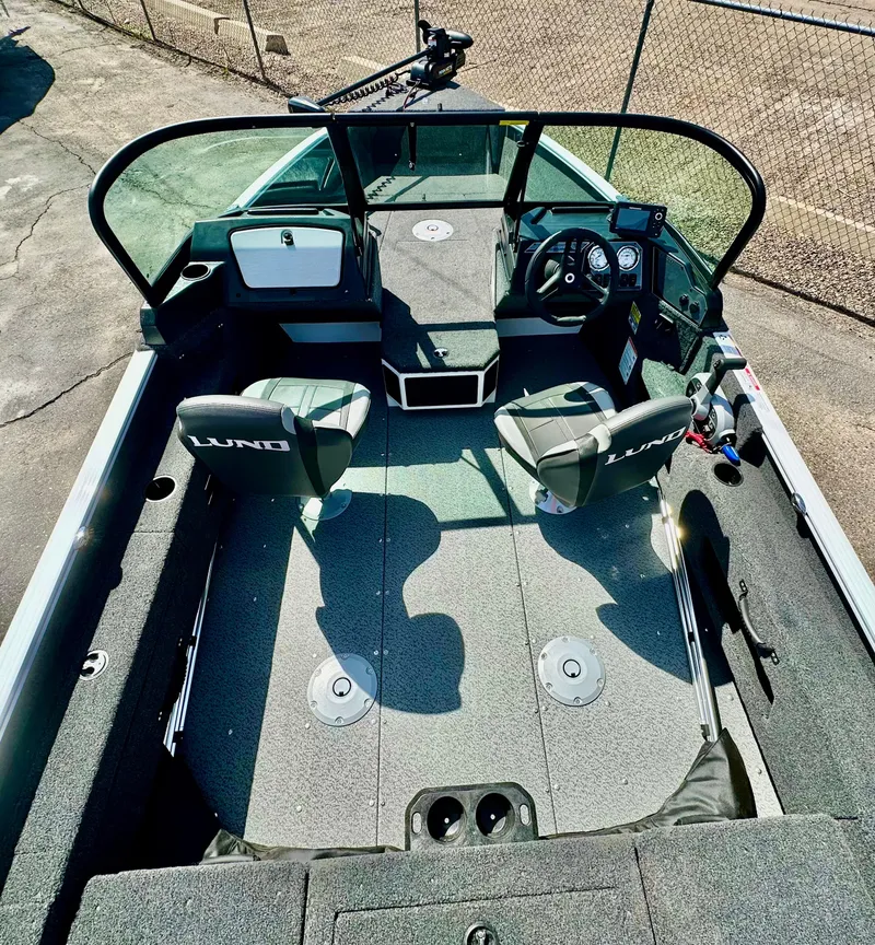 Slide: The Image of 2025 Lund 1775 Adventure Sport boat interior with seating and steering console. - 6
