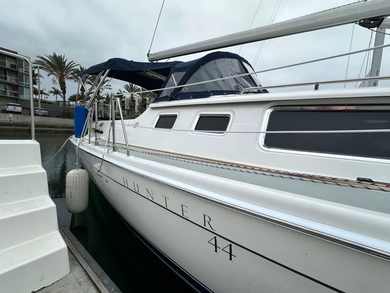 Slide: The Image of 2007 Hunter 44 Deck Salon yacht docked at marina, side view. - 10