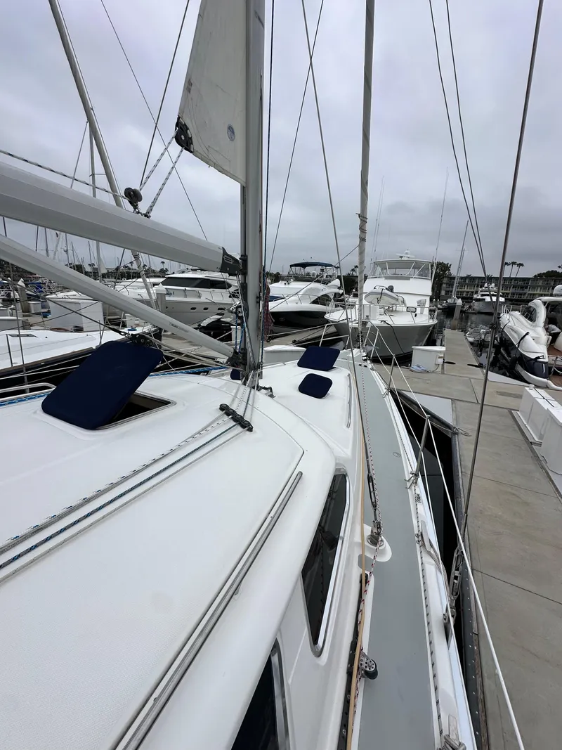 Slide: The Image of 2007 Hunter 44 Deck Salon sailboat docked in marina, overcast sky. - 14