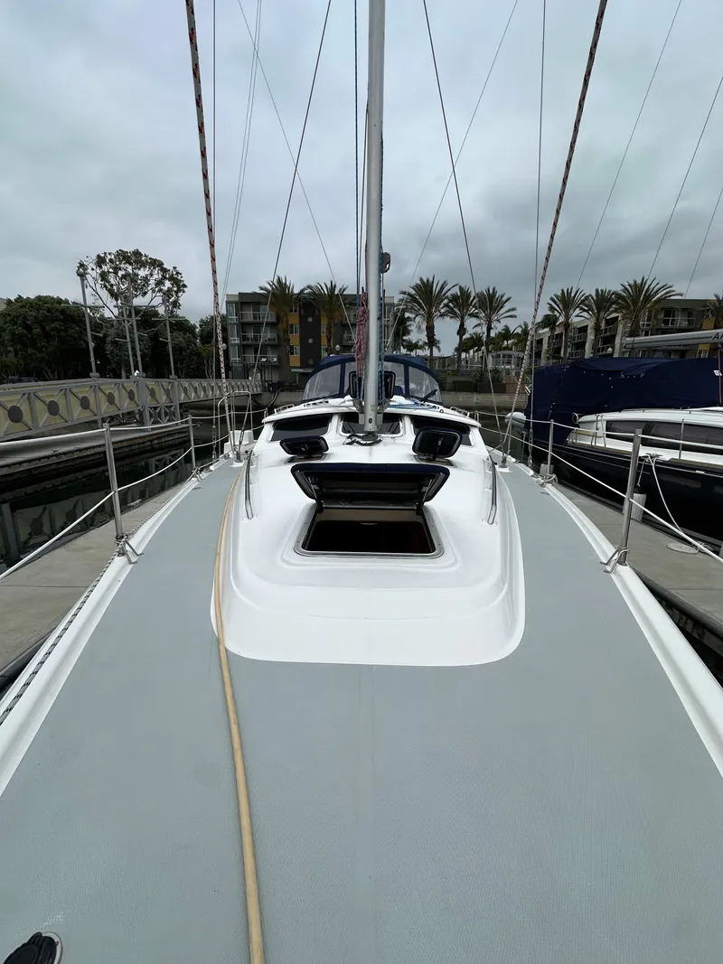Slide: The Image of 2007 Hunter 44 Deck Salon sailboat docked, showcasing sleek deck design and modern features. - 18