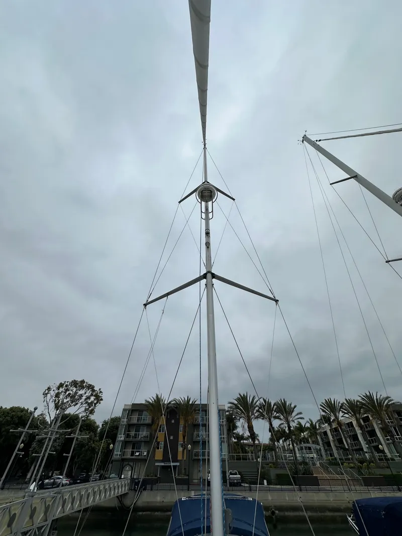 Slide: The Image of Mast of 2007 Hunter 44 Deck Salon sailboat against cloudy sky. - 19