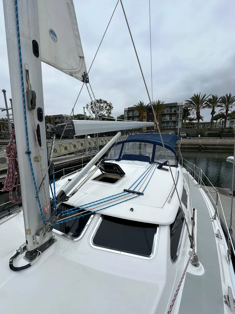 Slide: The Image of 2007 Hunter 44 Deck Salon sailboat docked at marina, overcast sky. - 20