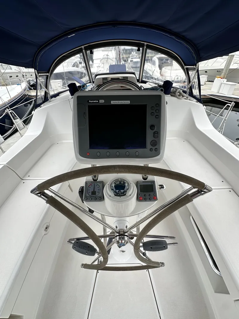 Slide: The Image of 2007 Hunter 44 Deck Salon cockpit with navigation system and steering wheel. - 28