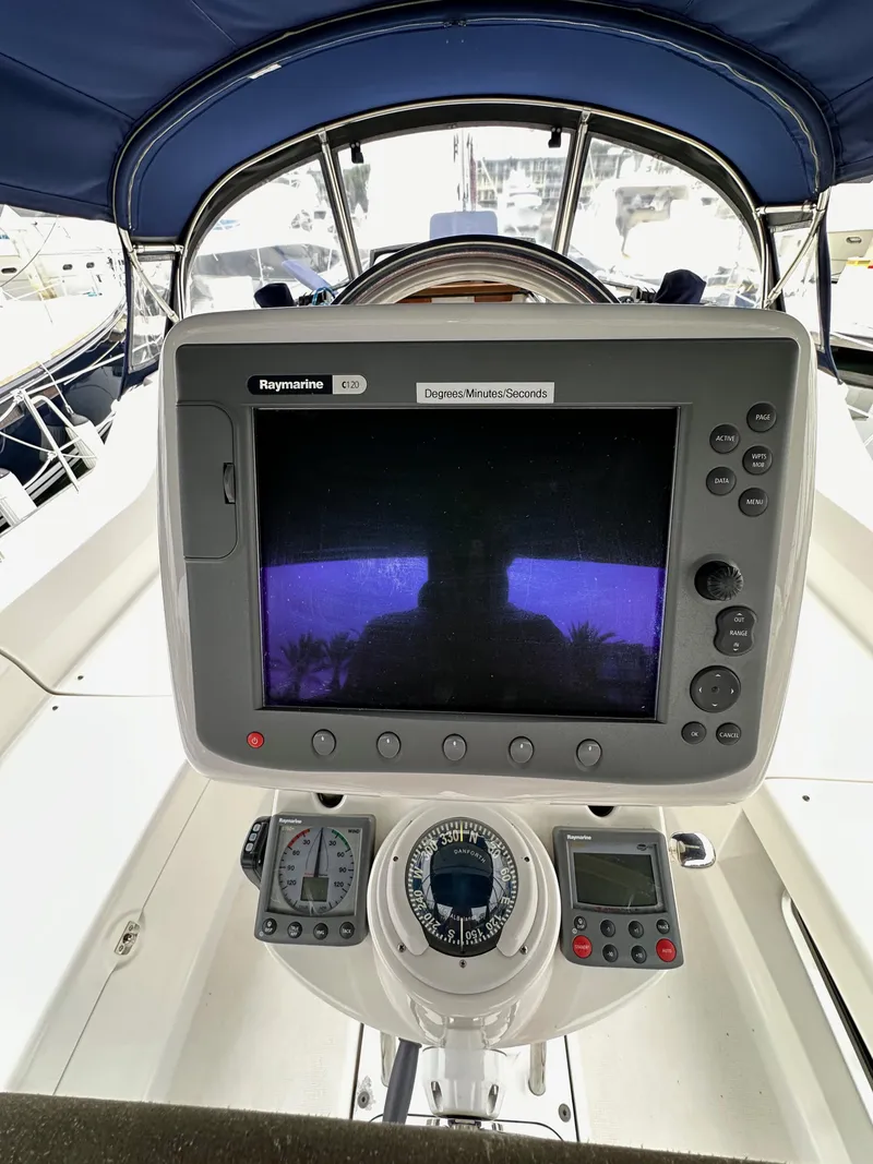 Slide: The Image of 2007 Hunter 44 Deck Salon cockpit with navigation equipment and steering wheel. - 29