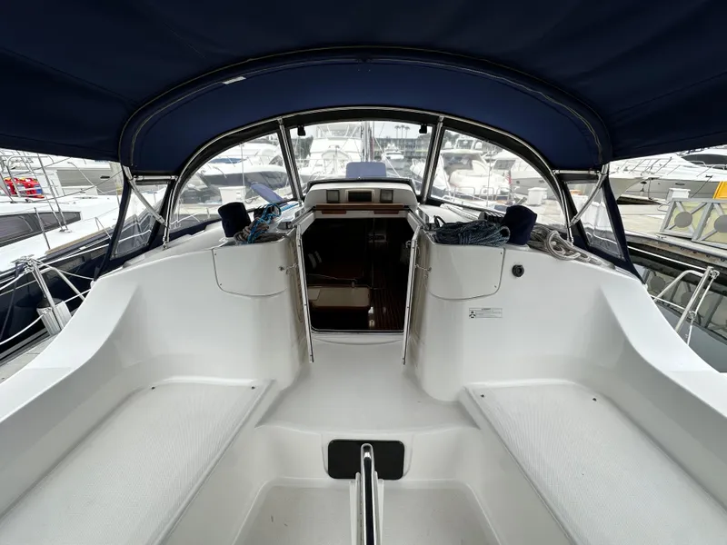 Slide: The Image of 2007 Hunter 44 Deck Salon yacht cockpit with blue canopy and spacious seating. - 34