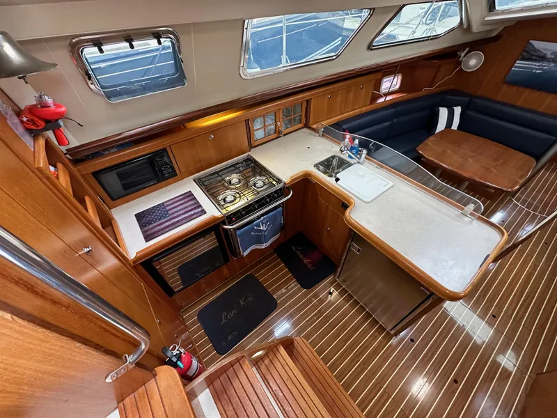 Slide: The Image of Interior of 2007 Hunter 44 Deck Salon with kitchen and seating area. - 40
